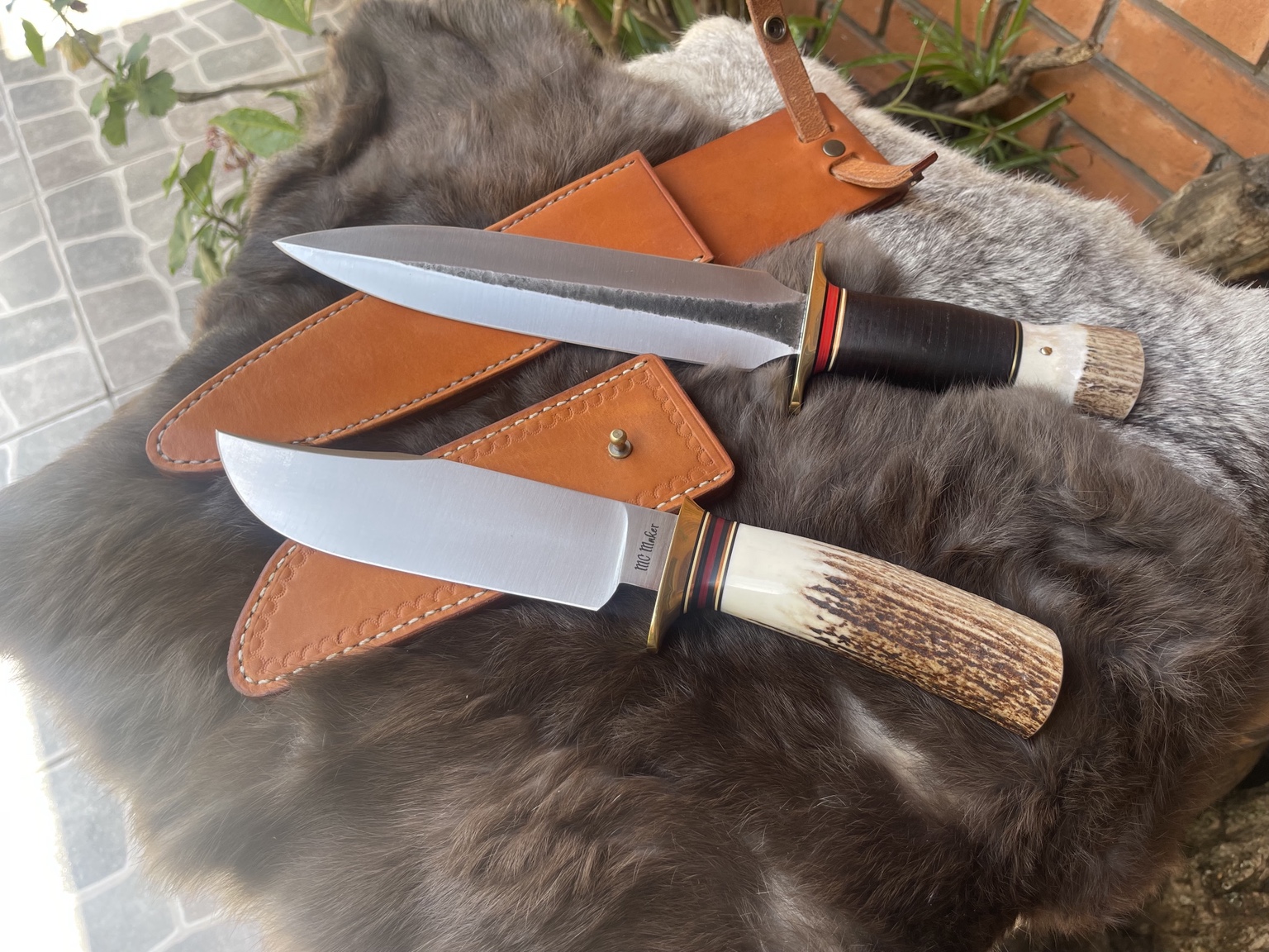 Pair of MC Knifemaker knives and leather sheaths
