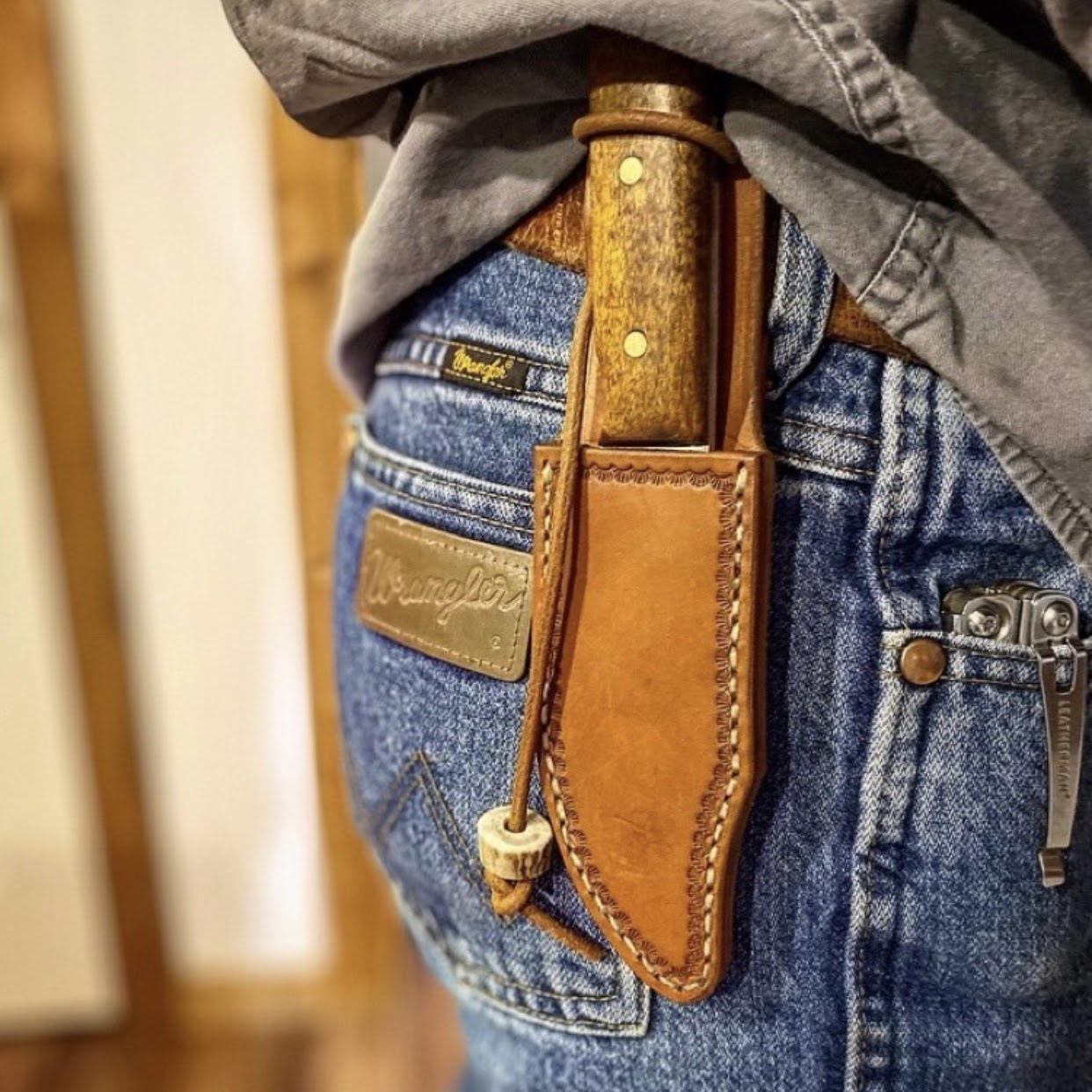 Handmade knife and leather sheath worn outdoors